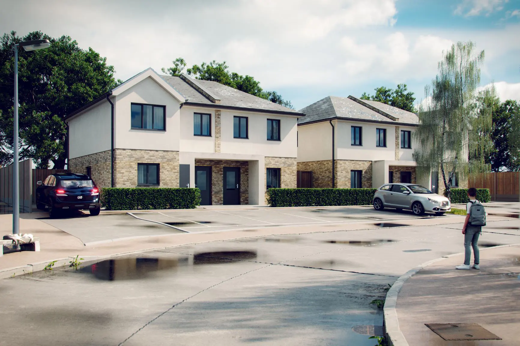 Two modern, semi-detached houses with brick and white facades in Essex; parked cars line the wet street as puddles reflect a person with a backpack, highlighting the architect’s careful party wall design.